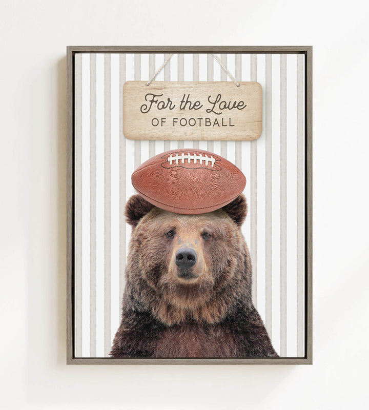 A framed image of a brown bear wearing a football helmet and standing in front of a sign that says "For the Love of Football".
