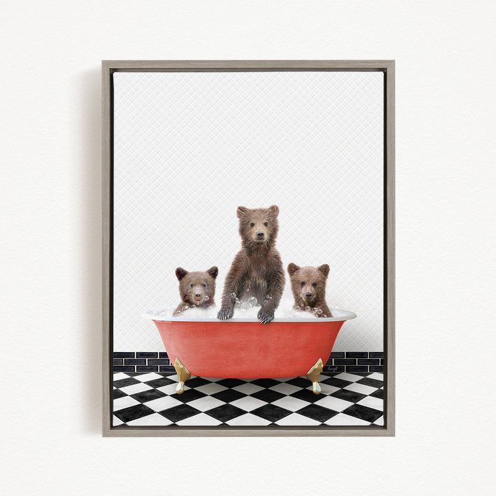 A framed image depicting three brown bears sitting in a red bathtub on a black and white checkered floor.
