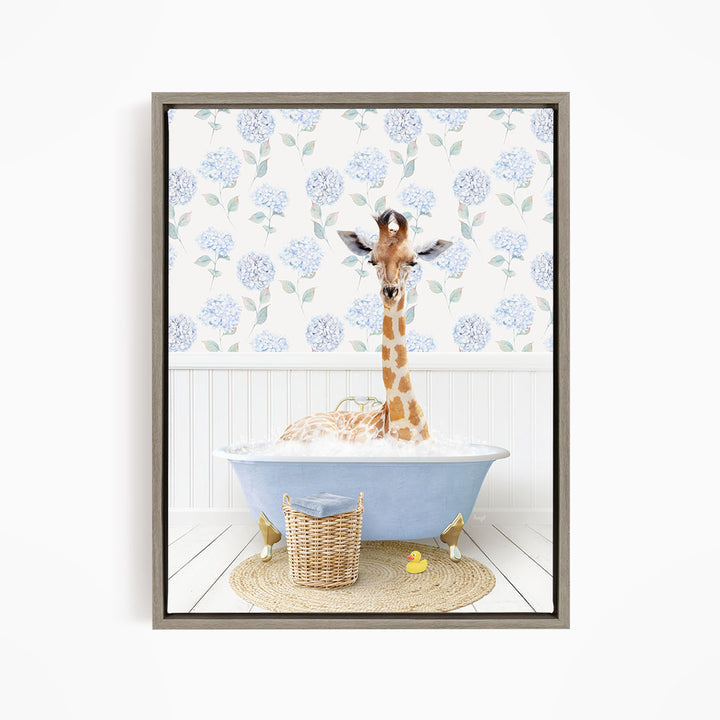 A giraffe is sitting in a blue bathtub filled with water, surrounded by a wicker basket and rubber ducks.