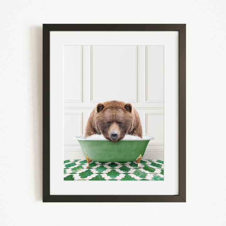 A brown bear is sitting in a green bathtub filled with water, appearing to be enjoying a relaxing bath.