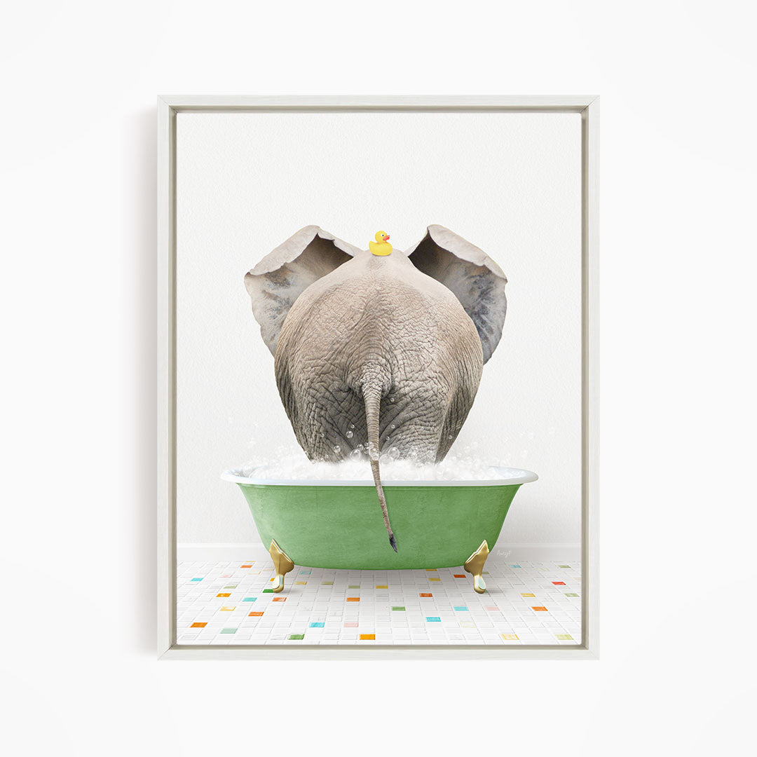 A gray elephant is standing in a green bathtub filled with water, with a yellow rubber duck perched on its head.