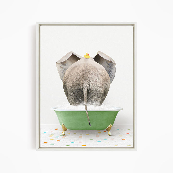 A gray elephant is standing in a green bathtub filled with water, with a yellow rubber duck perched on its head.