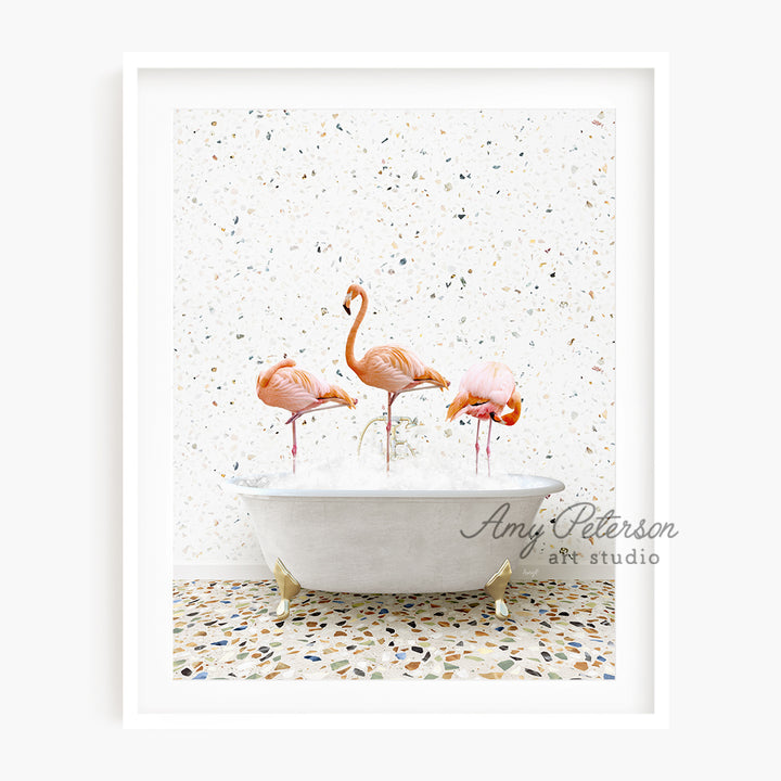 three pink flamingos in a bathtub with sprinkles