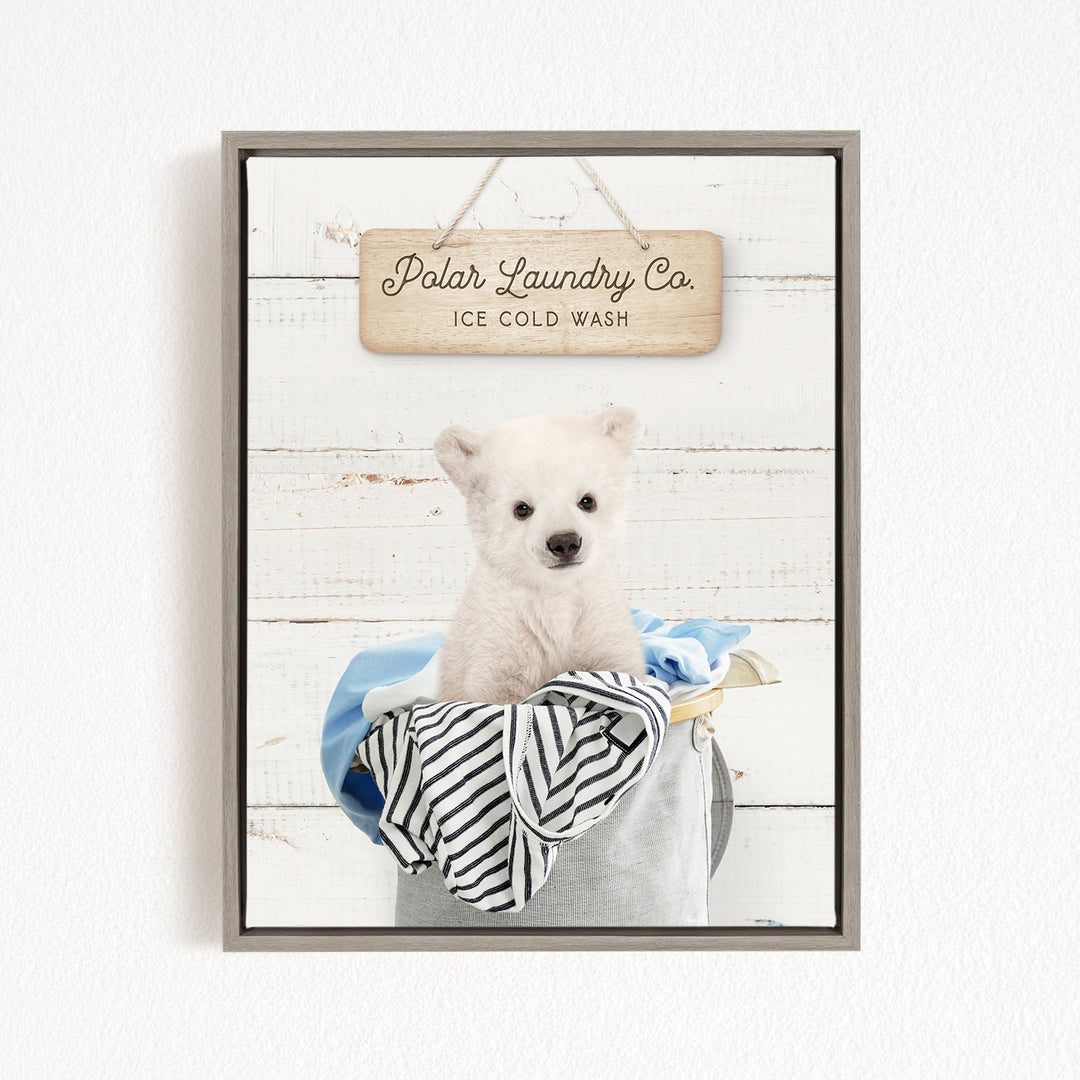 A white polar bear sitting in a laundry basket, with a wooden sign above that reads "Polar Laundry Co. Ice Cold Wash".