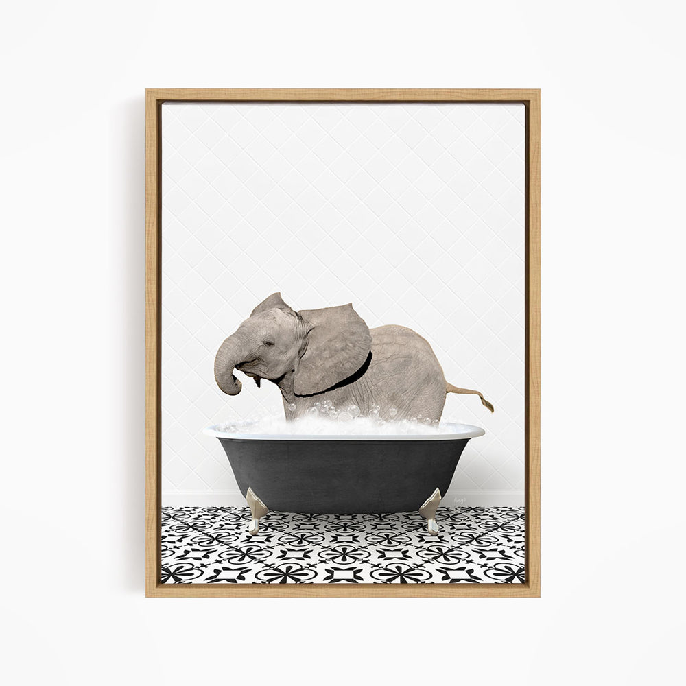 A gray elephant is sitting in a black bathtub filled with water, creating a whimsical and playful scene.
