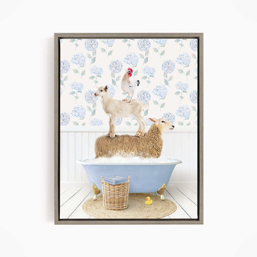 A framed image depicting a sheep standing on a tub filled with bubbles, with a chicken perched on top of it, and a rooster sitting on the sheep's back.