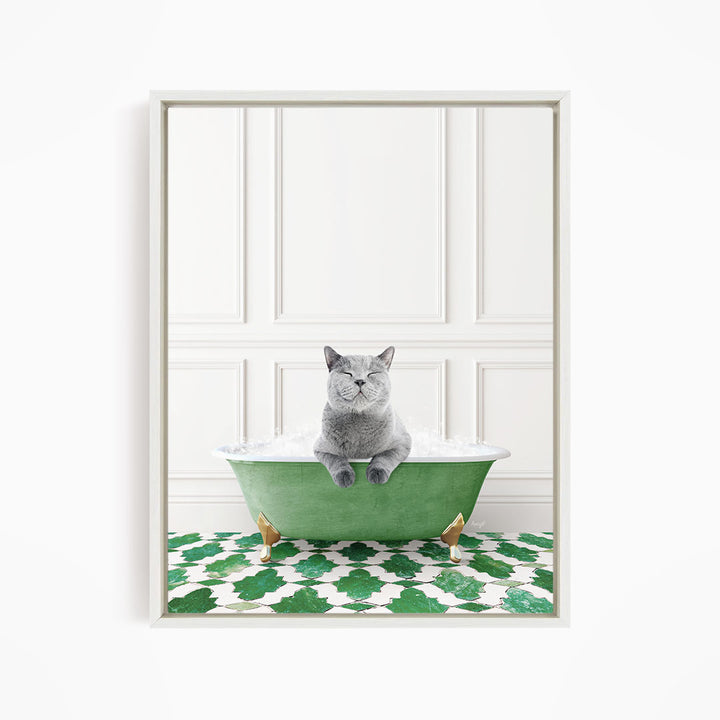 A gray cat sitting in a green bathtub filled with bubbles, with a patterned green and white floor in the background.