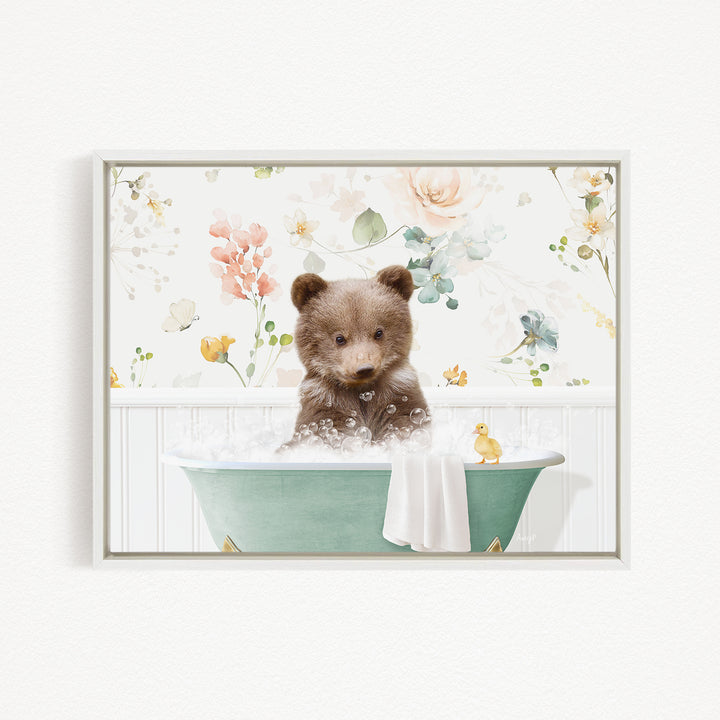 A cute brown bear sitting in a green bathtub filled with bubbles, surrounded by a floral wallpaper.