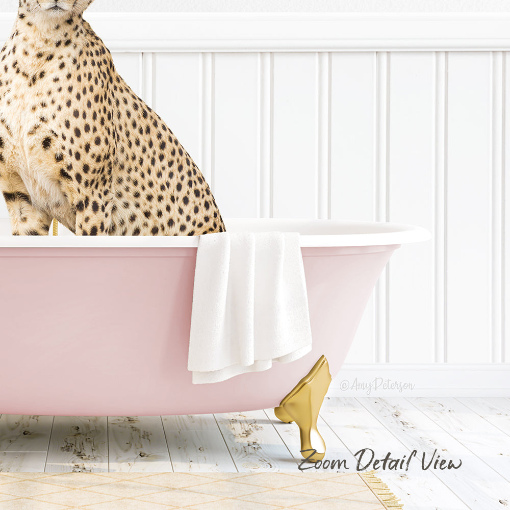 A leopard-spotted cat sitting in a pink bathtub, with a white towel and gold bathtub leg visible.