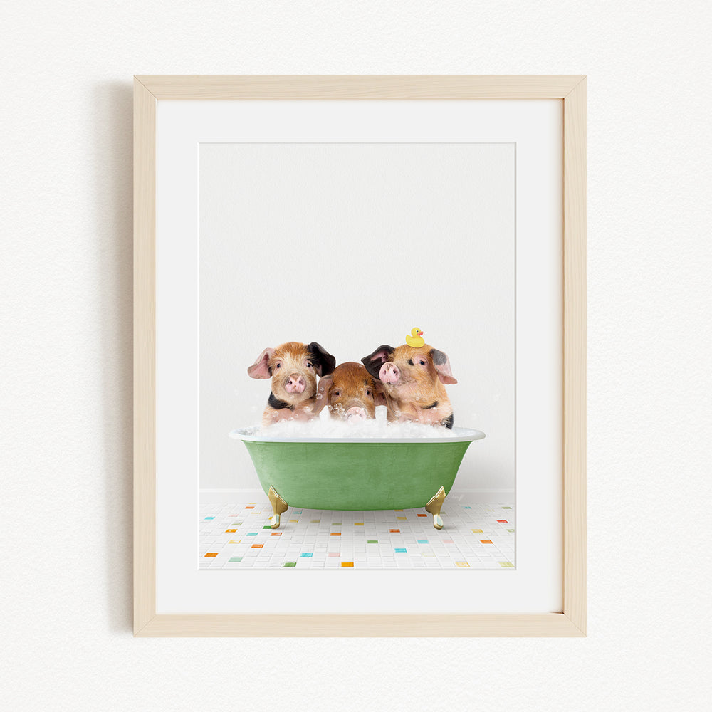 Three adorable pigs sitting in a green bathtub, enjoying a bath together.