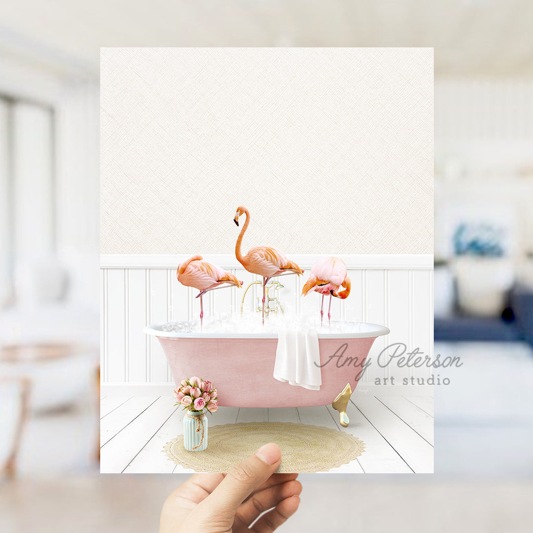 a person holding up a card with flamingos in a bathtub