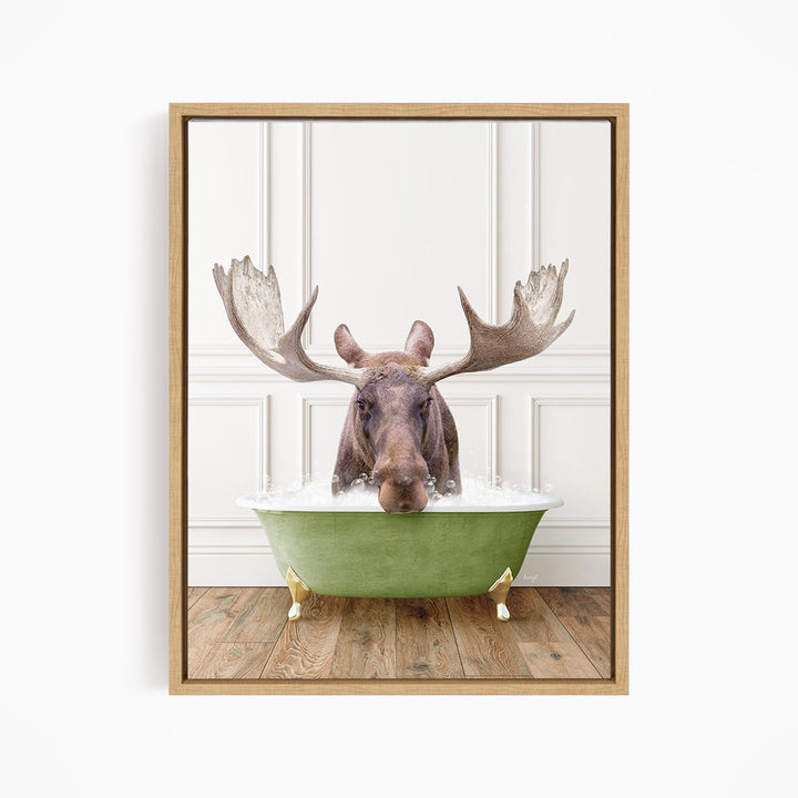 A moose with large antlers is sitting in a green bathtub filled with water, creating a whimsical and humorous scene.