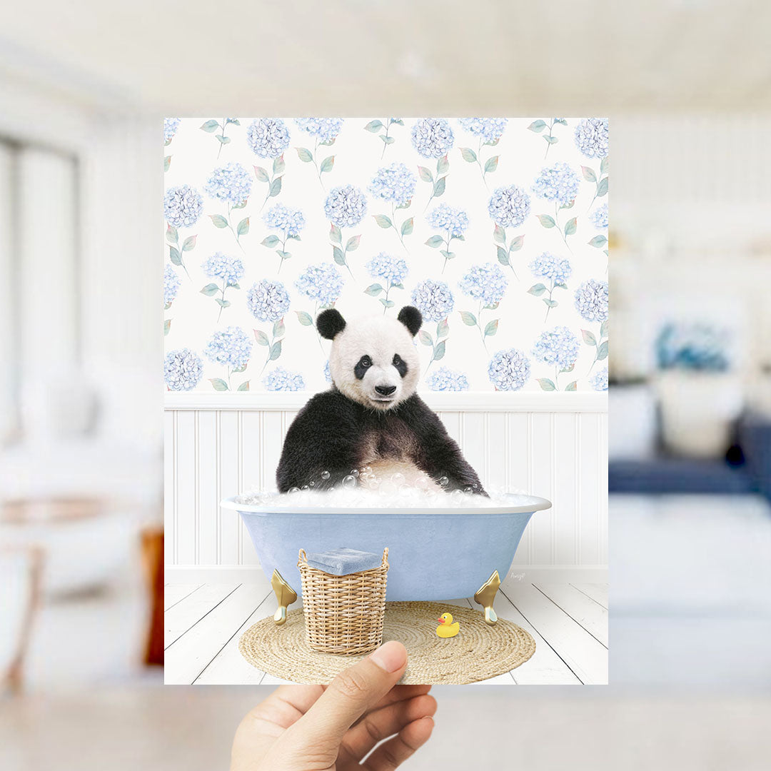 A panda bear sitting in a blue bathtub filled with bubbles, surrounded by a floral patterned wall.