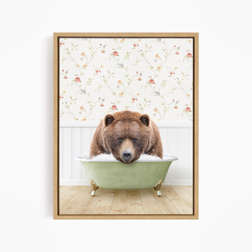 A brown bear is sitting in a green bathtub, with a floral wallpaper in the background.