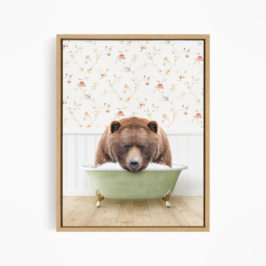 A brown bear is sitting in a green bathtub, with a floral wallpaper in the background.