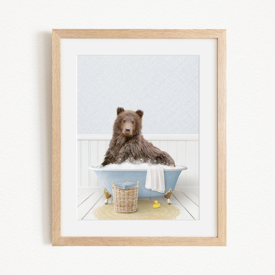 A brown bear sitting in a blue bathtub filled with water, surrounded by rubber ducks and a basket.