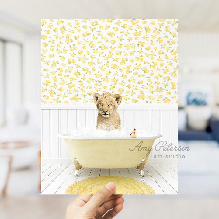 a person holding up a picture of a baby bear in a bathtub