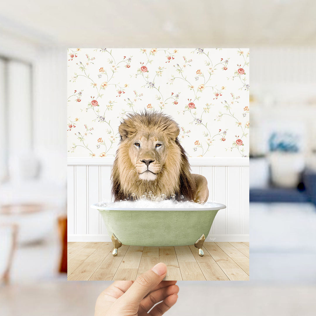 A lion sitting in a green bathtub filled with bubbles, with a floral patterned wall behind it.