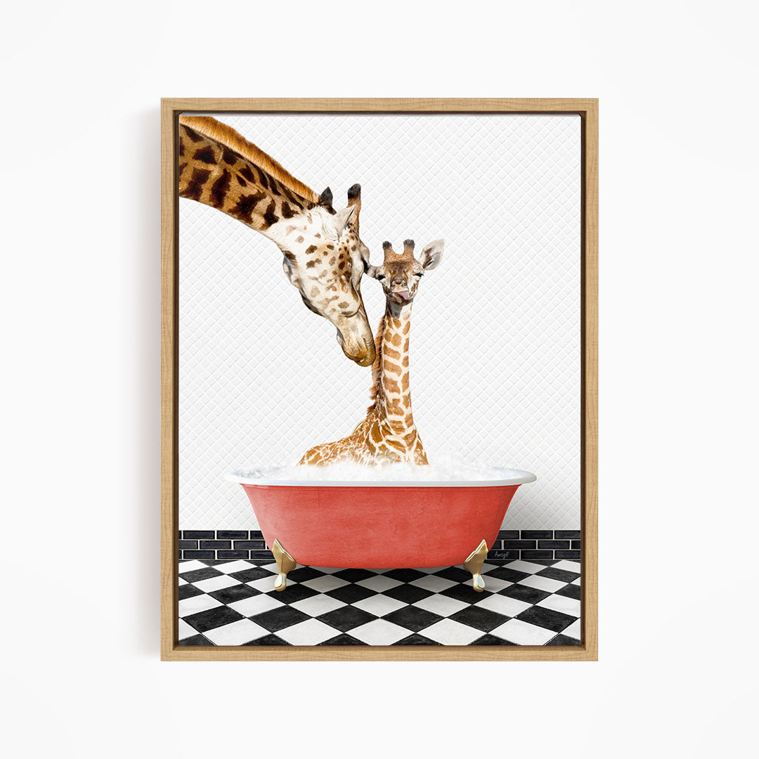 A mother giraffe and her baby giraffe are sitting in a red bathtub, with the mother gently nuzzling her baby.