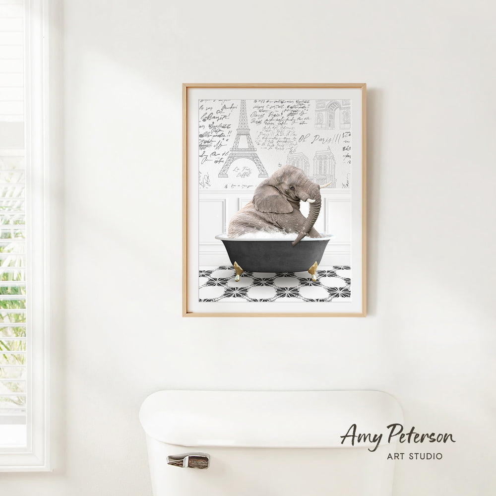 A framed image of an elephant sitting in a bathtub, with the Eiffel Tower and other architectural drawings visible in the background.