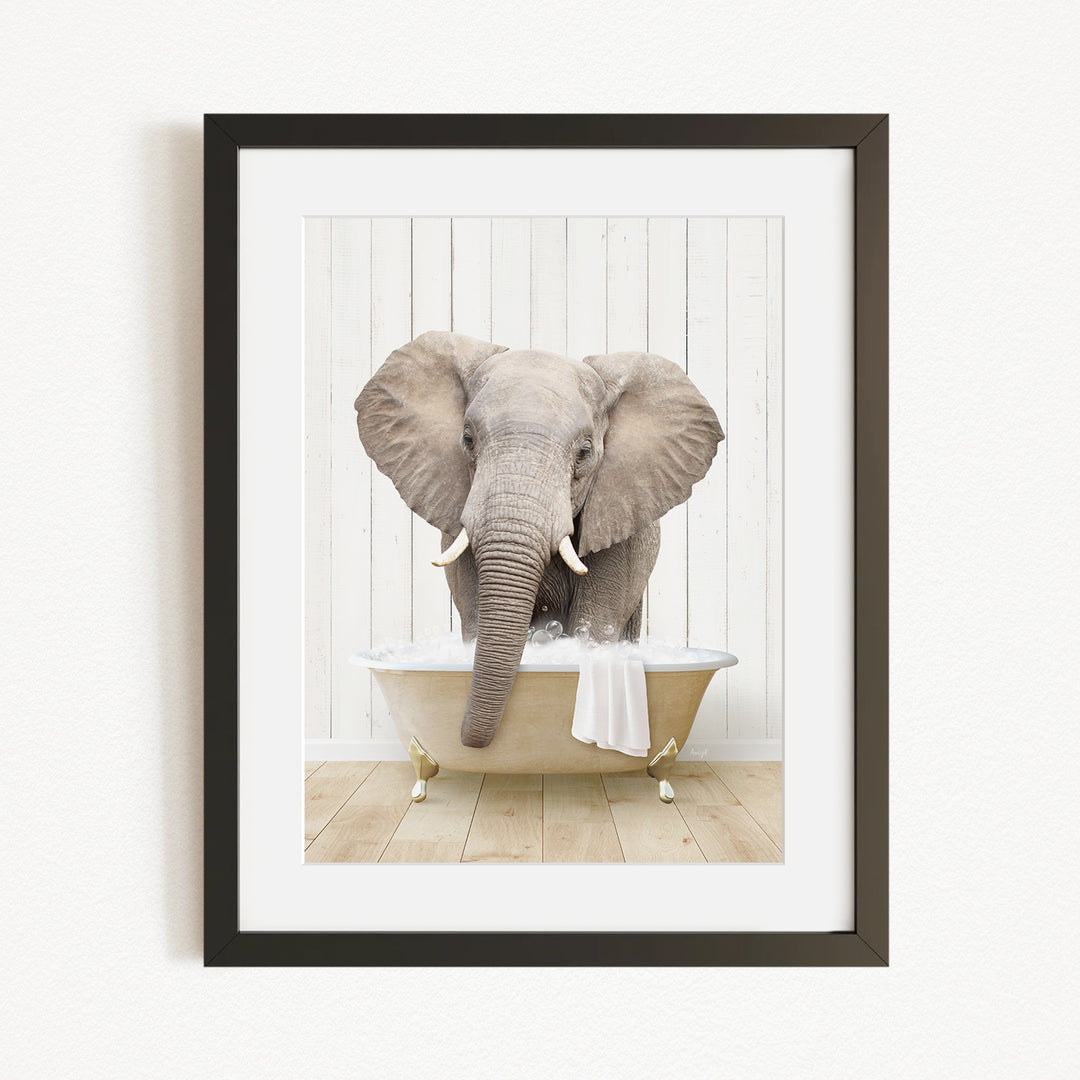 A gray elephant is sitting in a white bathtub, with its trunk extended towards the water.