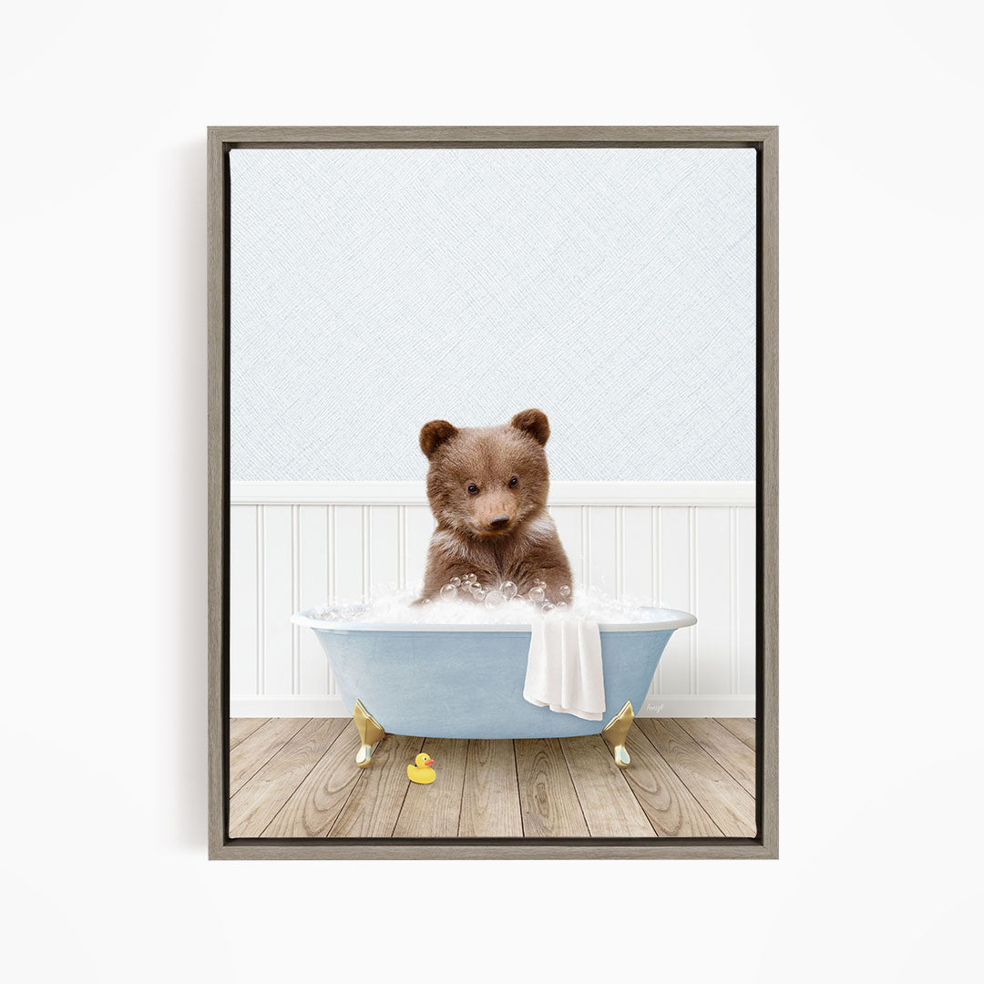 A brown bear sitting in a blue bathtub filled with water, surrounded by rubber ducks.