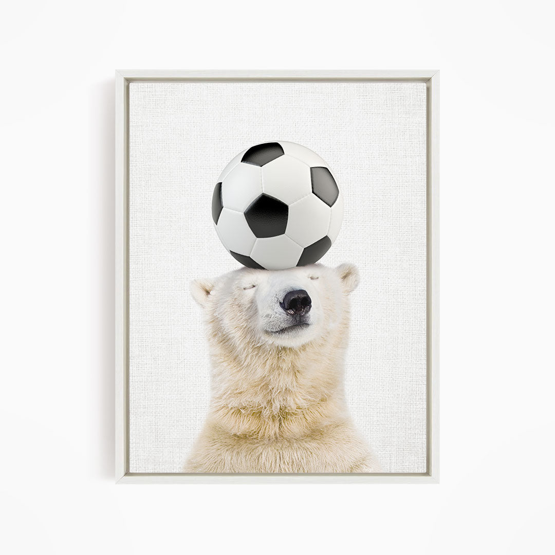 A polar bear balancing a soccer ball on its head.