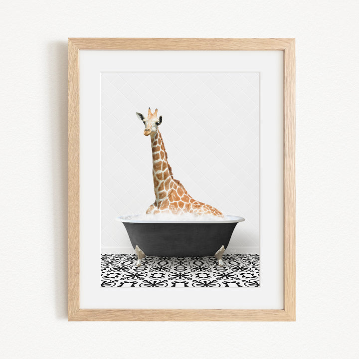 A giraffe is sitting in a black bathtub filled with water, creating a whimsical and playful scene.