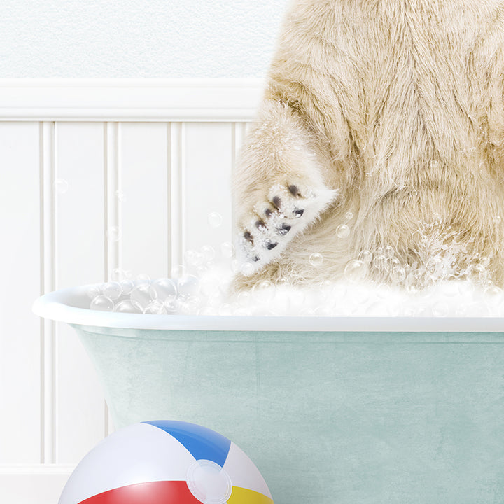 a polar bear in a bath tub with a beach ball