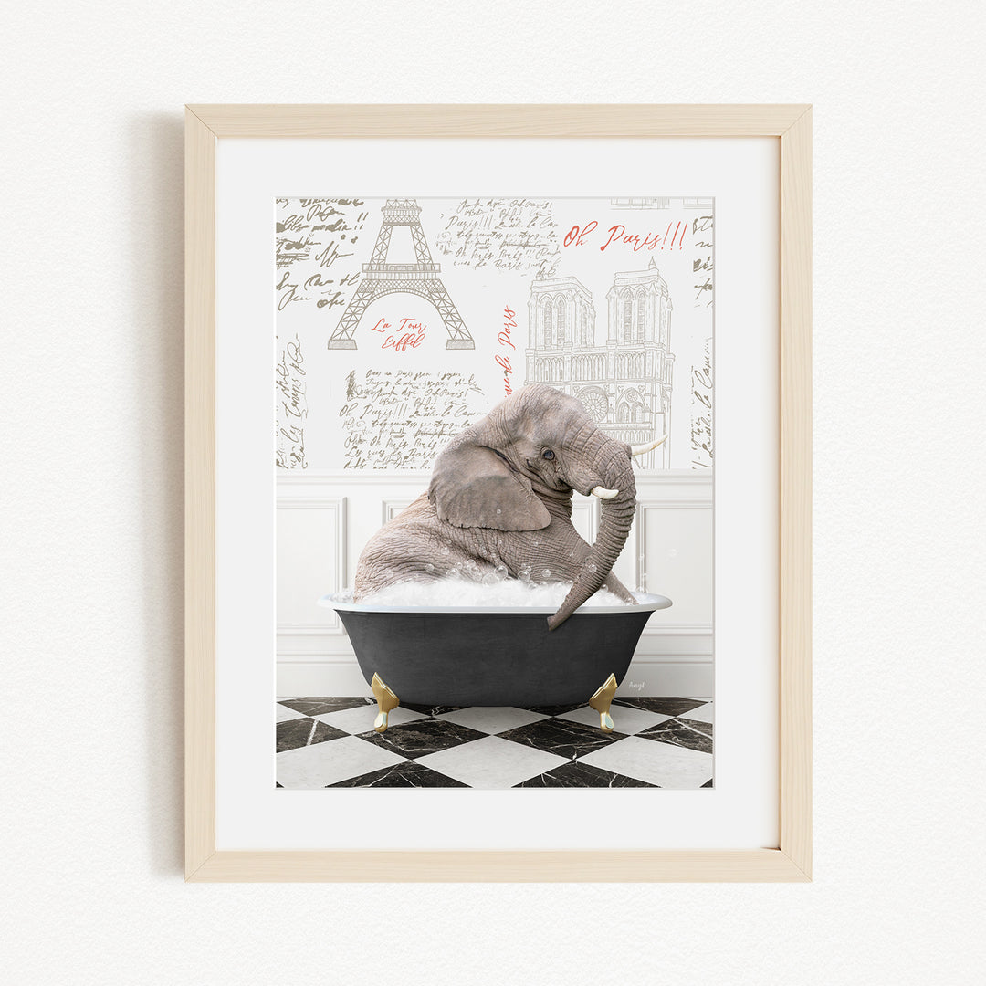 A framed image depicting an elephant sitting in a bathtub, with a Paris-themed background featuring the Eiffel Tower and other Parisian landmarks.