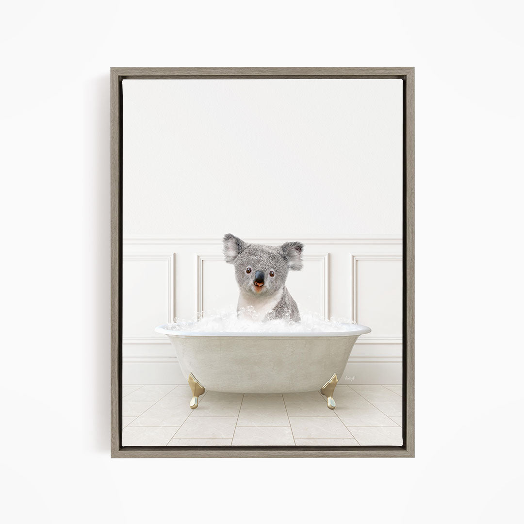 A koala bear sitting in a white bathtub filled with water, looking directly at the camera.