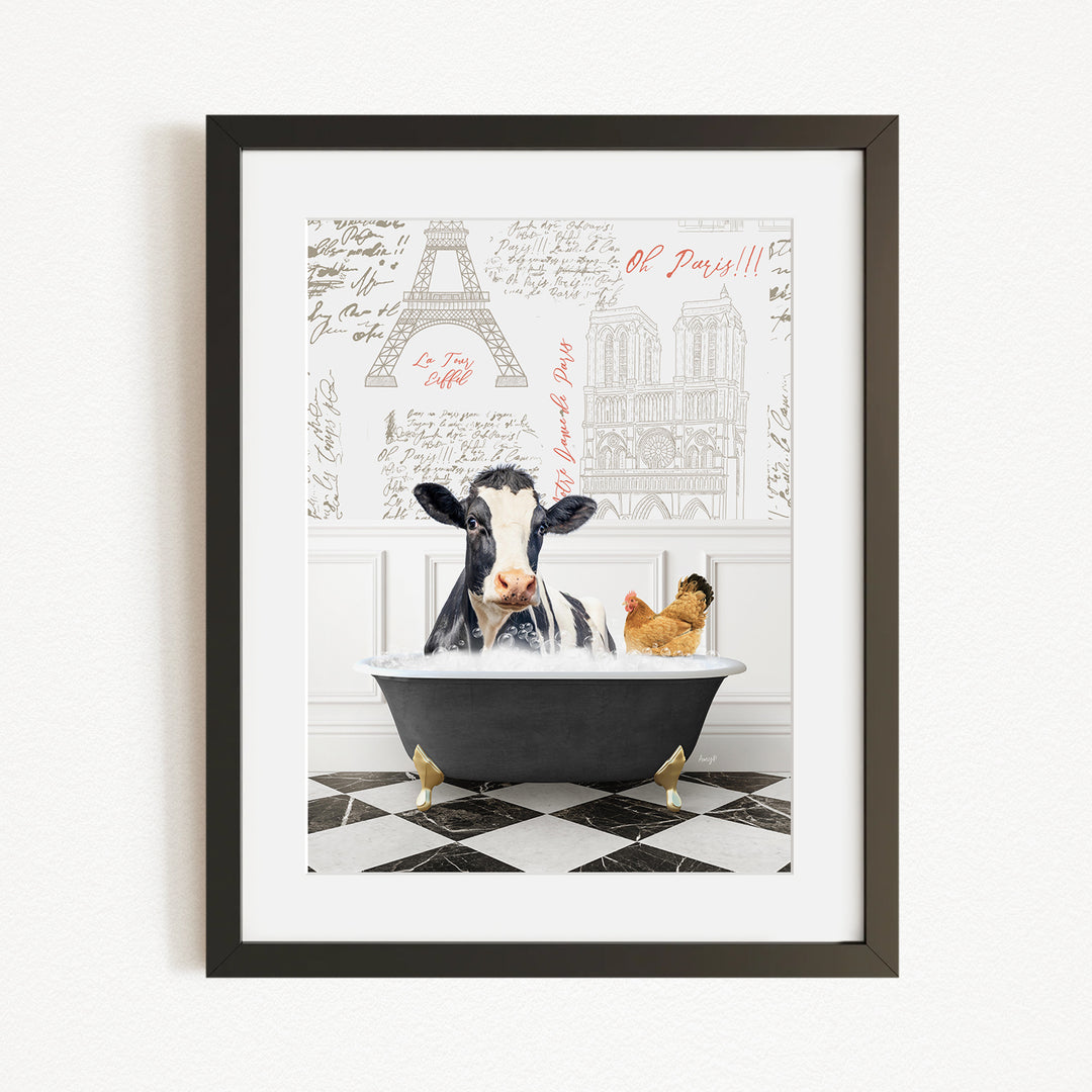 A framed image depicting a cow sitting in a bathtub, with a chicken nearby, against a backdrop of the Eiffel Tower and other Parisian landmarks.