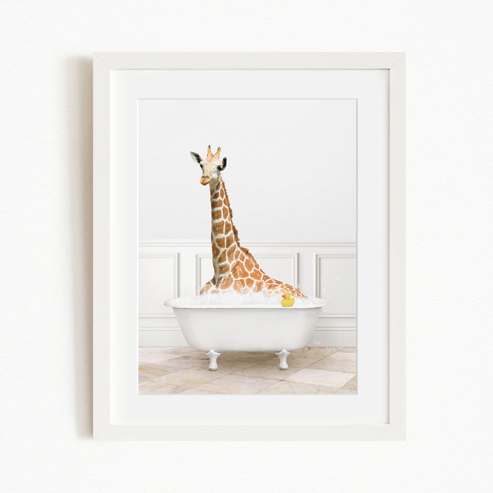 A giraffe is sitting in a white bathtub filled with water, with a yellow rubber duck floating nearby.