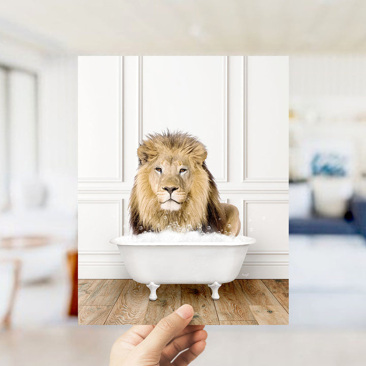 A lion sitting in a white bathtub filled with bubbles, with a blurred background suggesting a living room setting.