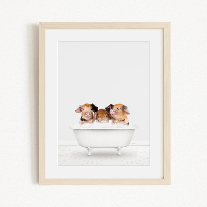 Three adorable brown and white pigs sitting in a white bathtub, enjoying a relaxing bath.