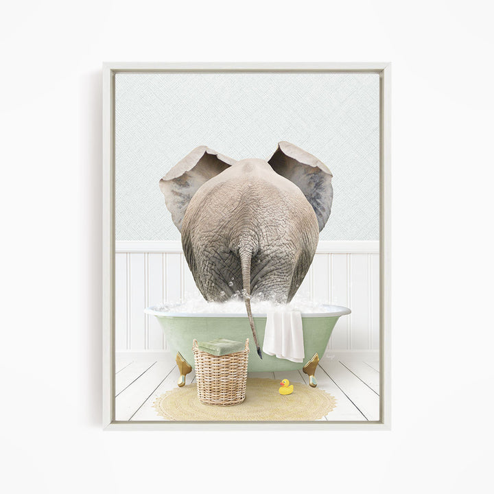 A gray elephant is standing in a green bathtub filled with water, surrounded by a yellow rubber duck and a basket.