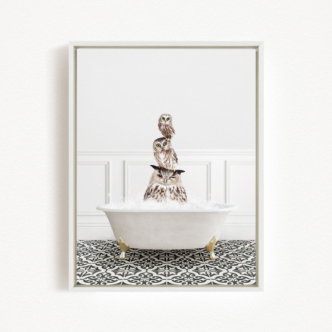 A framed image depicting a white bathtub filled with water, with three owls perched on top of it, creating a whimsical and playful scene.