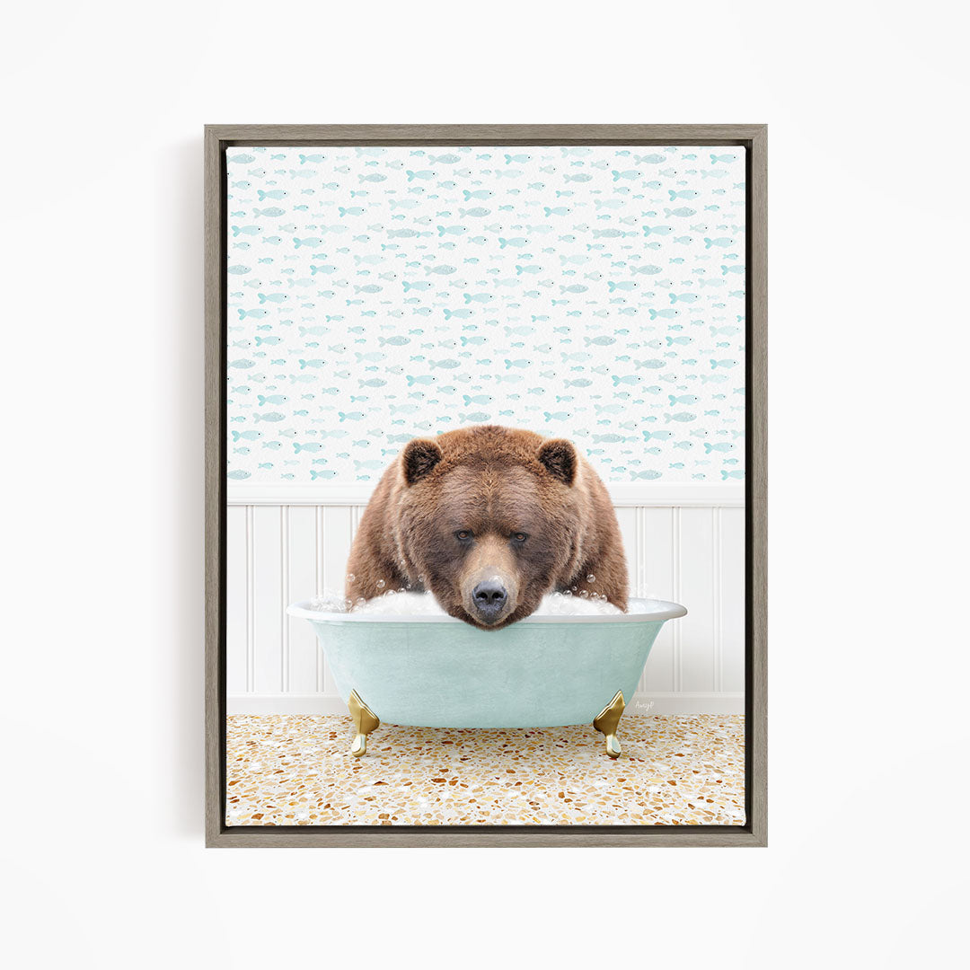 A brown bear is sitting in a blue bathtub filled with water, surrounded by a pattern of fish.