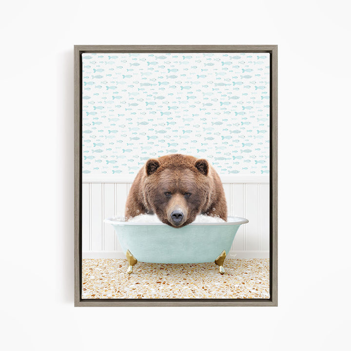 A brown bear is sitting in a blue bathtub filled with water, surrounded by a pattern of fish.