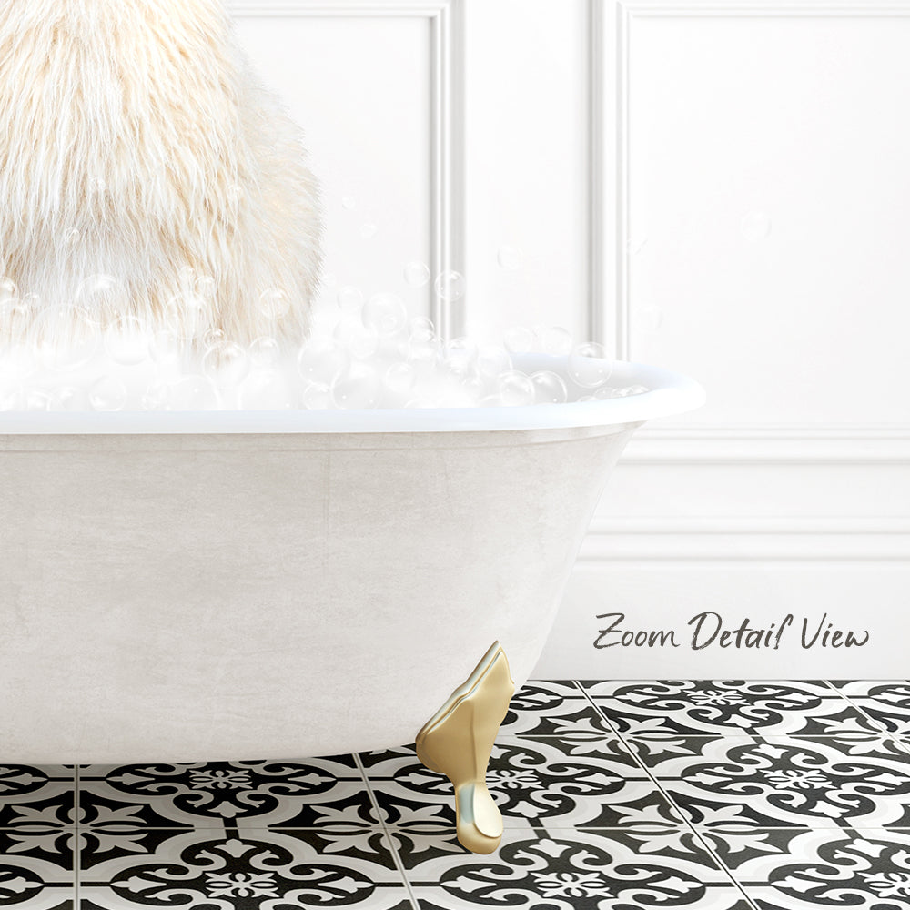 A white bathtub filled with bubbles, with a gold claw-footed design on the floor.