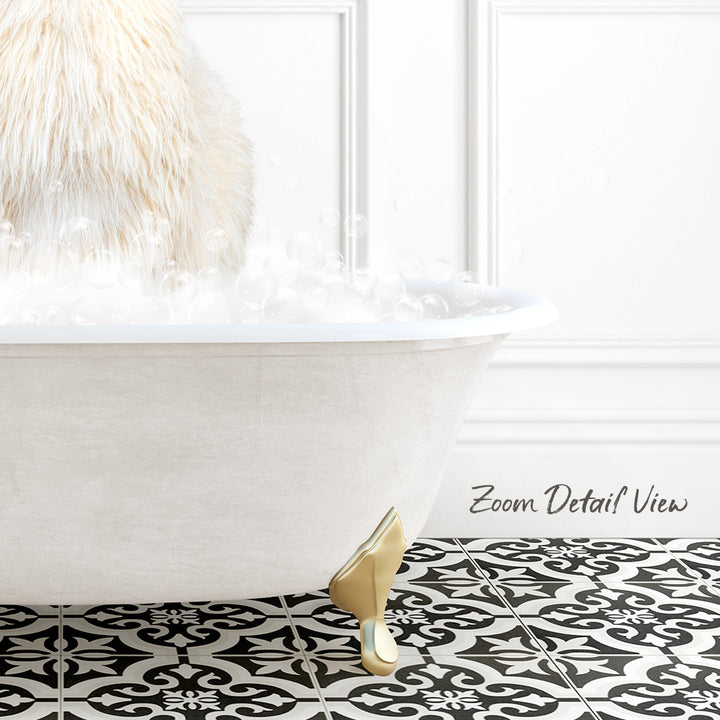 A white bathtub filled with bubbles, with a gold claw-footed design on the floor.