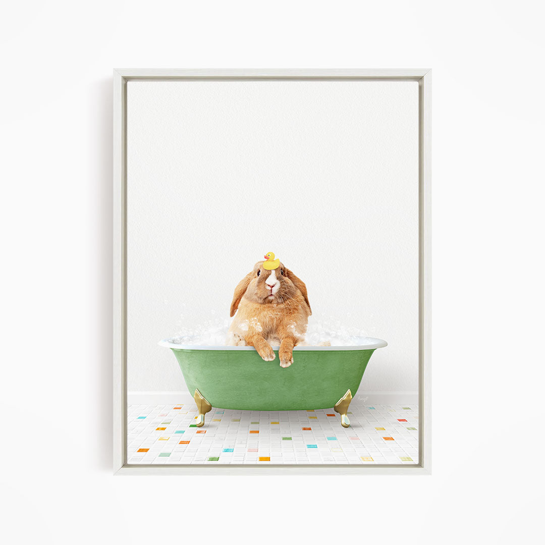 A brown rabbit sitting in a green bathtub filled with bubbles, wearing a yellow rubber duck hat.