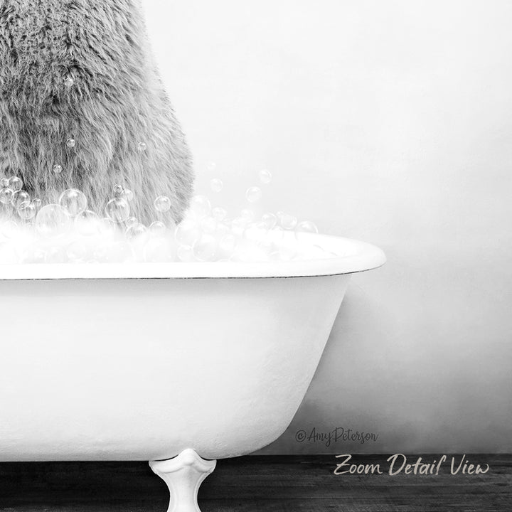 A fluffy gray cat sitting in a white bathtub filled with bubbles, creating a whimsical and playful scene.