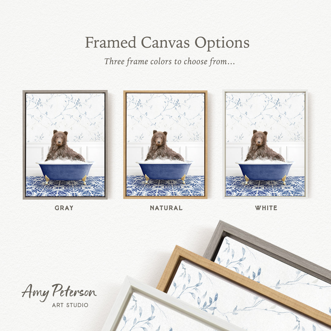 three framed canvas options featuring a brown bear sitting in a blue bathtub. The options include three different frame colors: gray, natural, and white.