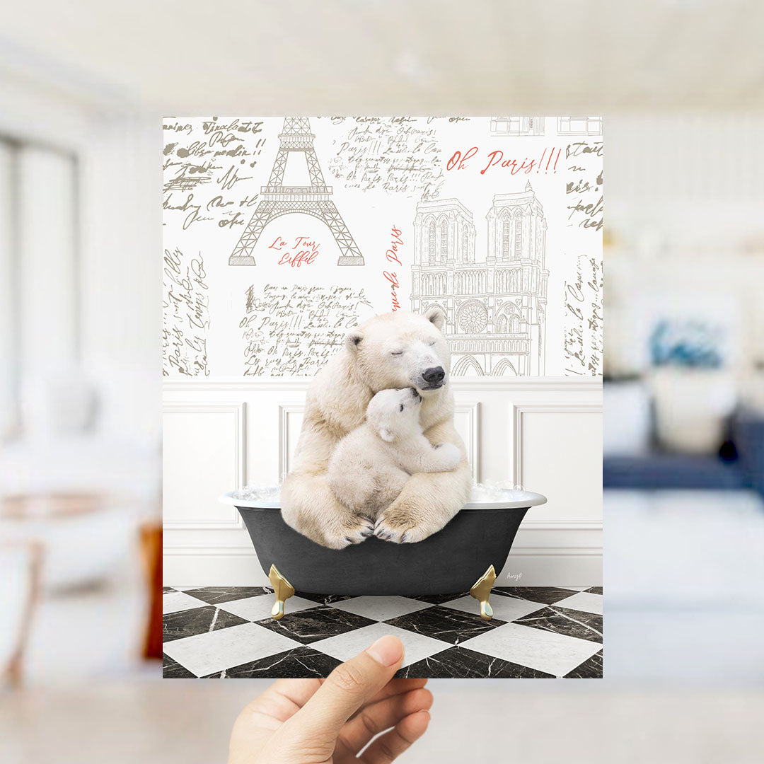 A polar bear is sitting in a bathtub, with a baby bear nestled next to it, in front of a wall with various Paris-themed illustrations.