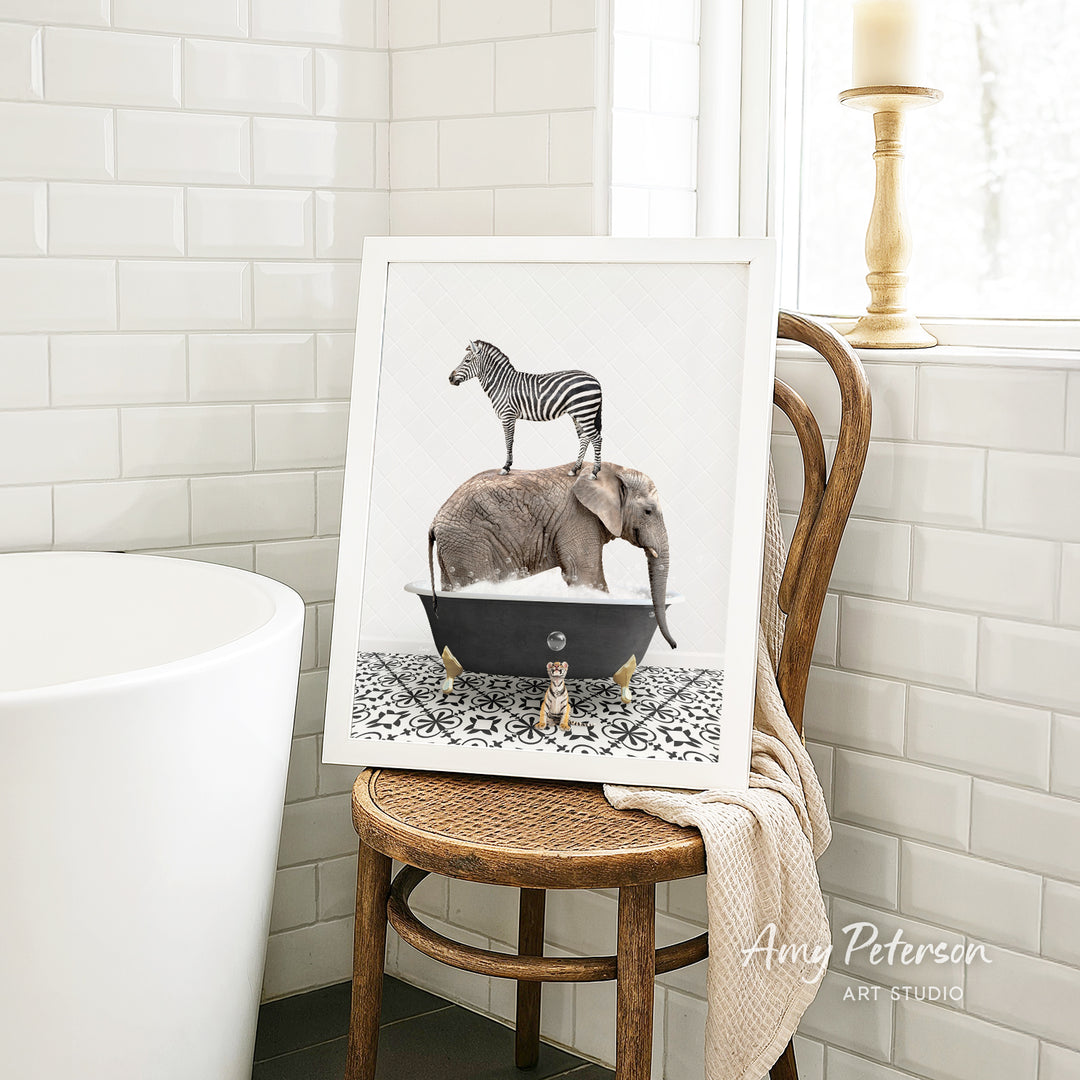 A framed image of a zebra standing on an elephant's back, both in a bathtub, is displayed on a wooden chair in a bathroom setting.