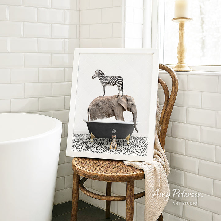A framed image of a zebra standing on an elephant's back, both in a bathtub, is displayed on a wooden chair in a bathroom setting.
