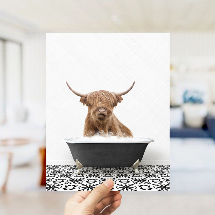 A Highland cow with long horns is sitting in a bathtub filled with water, creating a whimsical and amusing scene.