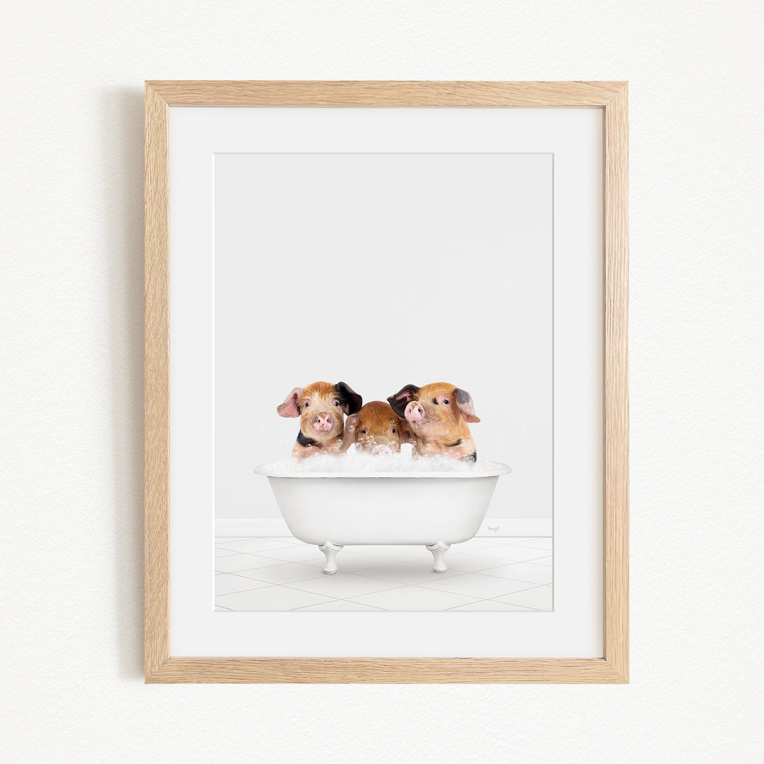 Three adorable brown and white pigs sitting in a white bathtub, enjoying a relaxing bath.