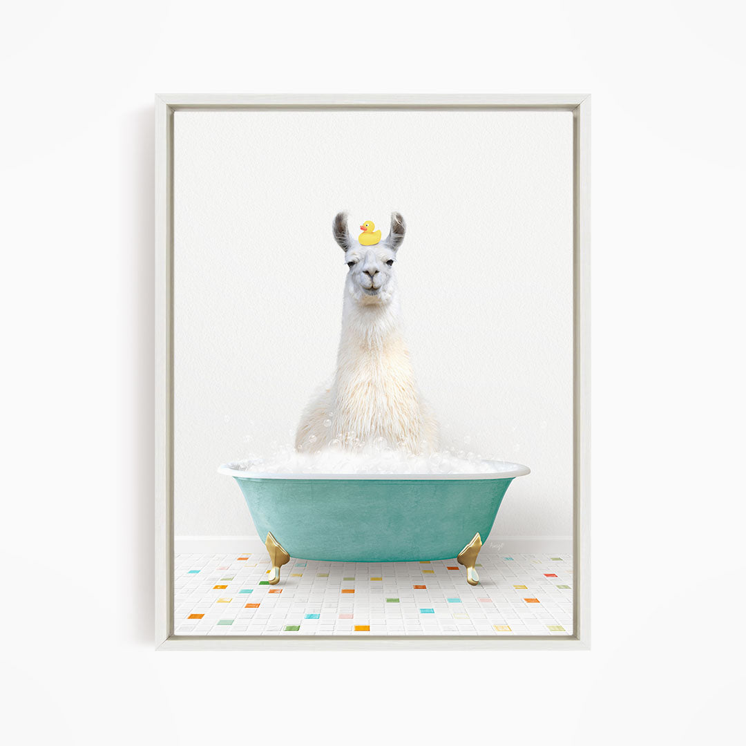 A white llama sitting in a green bathtub filled with bubbles, with a yellow rubber duck floating on top.